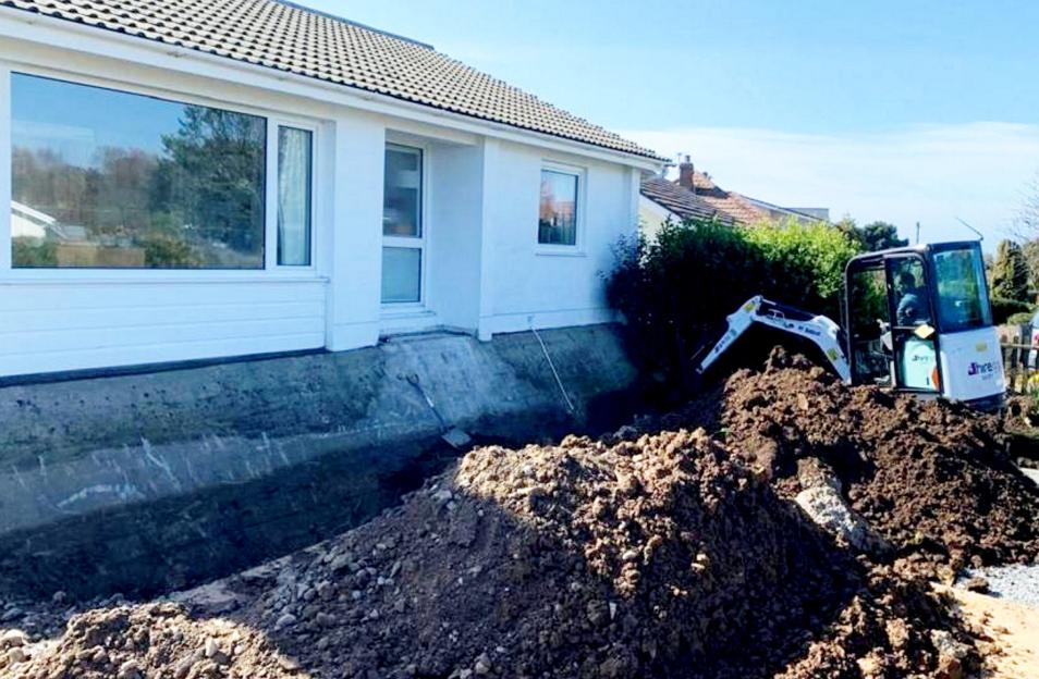 Excavation revealing a World War II bunker under a house.