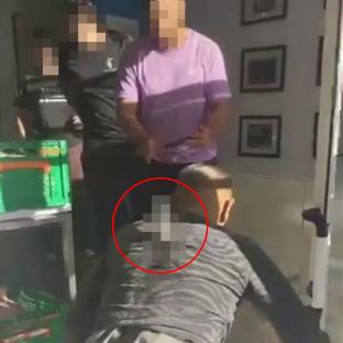 A stabbed man crawls on the floor.
