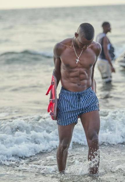 Nicolas Jackson at the beach, holding a flotation device.