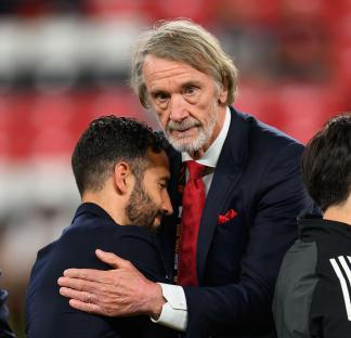 Sir Jim Ratcliffe consoling Ruben Amorim after a soccer game.
