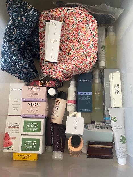 A makeup bag overflowing with various beauty products.