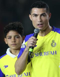 Cristiano Ronaldo, Georgina Rodriguez, and Cristiano Ronaldo Jr. at a press conference.