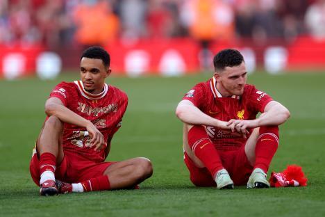 Trent Alexander-Arnold and Andrew Robertson of Liverpool sitting on the field.