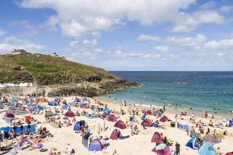 Crowded beach with people enjoying the summer.