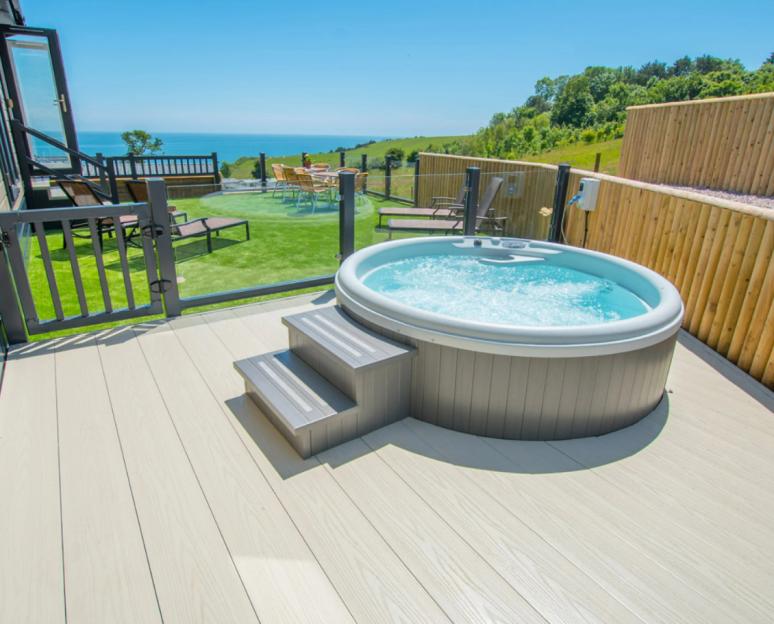 Hot tub on a deck overlooking the ocean.