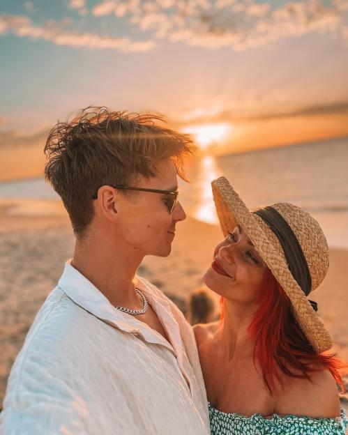 Joe Sugg and Dianne Buswell at sunset on a beach.