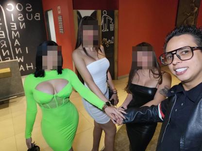 Photo of Alex Marin with three women; faces blurred.