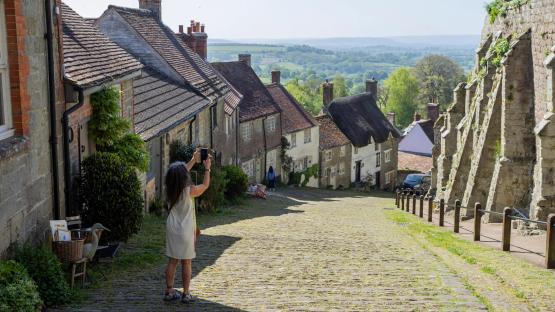 We live on hill made famous by iconic advert – but it’s flooded by tourists playing theme tune… they think we’re actors