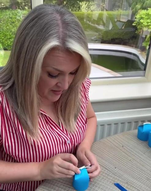 Woman making inexpensive birthday party favors.