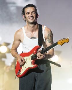 Matty Healy of The 1975 playing guitar at Lollapalooza.
