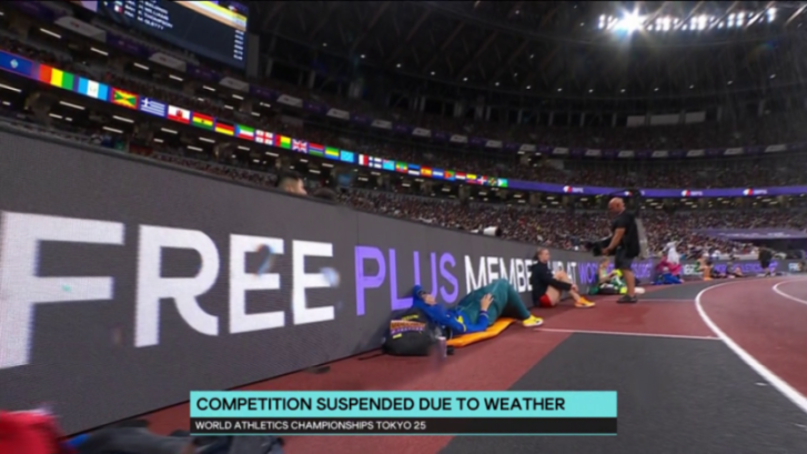World Athletics Championships suspended due to weather with athletes resting by the track.