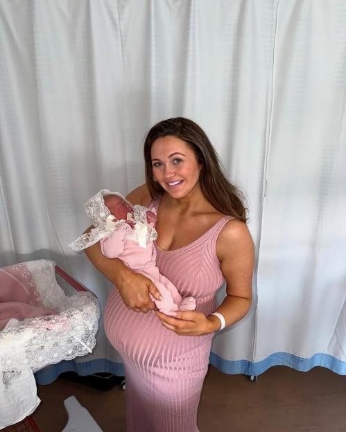 Woman holding her newborn baby girl.