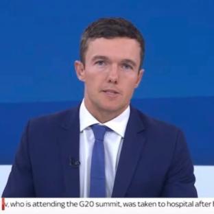 Man in suit speaking.