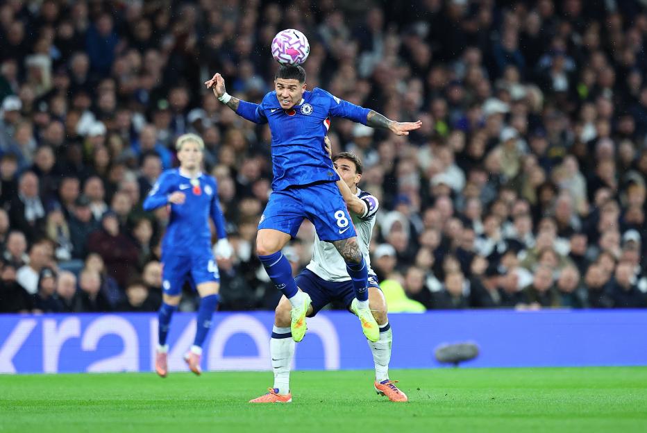 Enzo Fernandez of Chelsea jumping to head the ball during a Premier League match against Tottenham Hotspur.