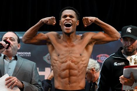 Devin Haney flexing his muscles at a boxing weigh-in.