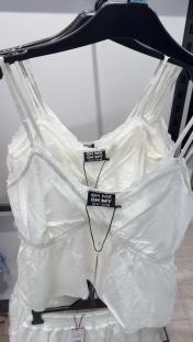 White eyelet cami and shorts set on hangers.