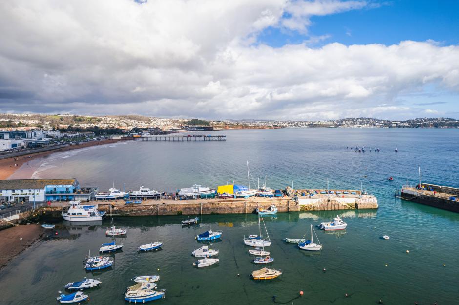 Aerial view of Paignton Harbour and South Quay with boats docked and anchored in the water, Paignton, Devon, England.