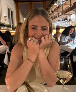Woman smiling at a restaurant table.