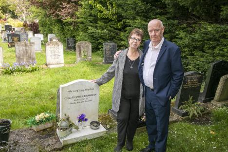 Couple at son's graveside.