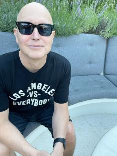 Mark Hoppus smiling and wearing sunglasses.