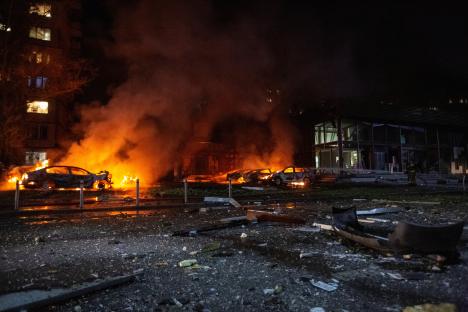 Burning cars and debris at the site of a Russian drone strike in Kyiv, Ukraine.