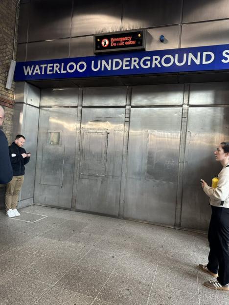Closed Waterloo Underground station entrance with a sign indicating an emergency.