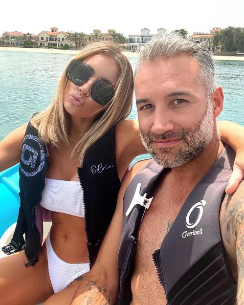 Laura Anderson and Dane Bowers wearing life vests on a boat.
