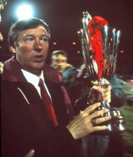 Alex Ferguson celebrating with the European Cup Winners' Cup trophy after Manchester United's victory.