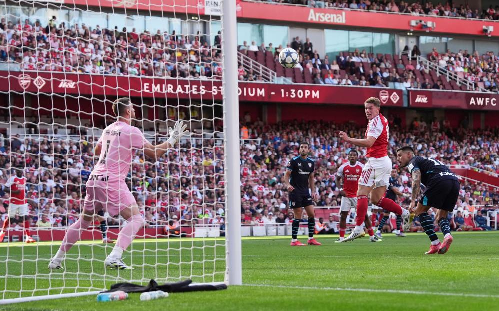 Soccer player scoring a goal.