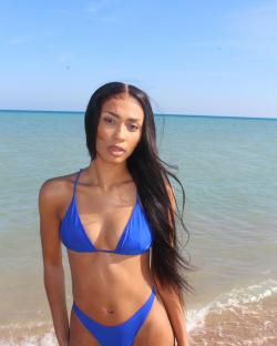 Woman in blue bikini at the beach.