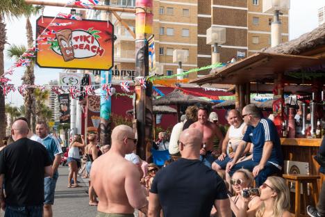 Patrons at a Tiki Beach Bar in Benidorm, Spain.