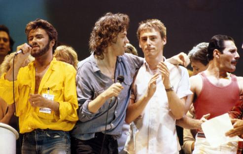 George Michael, Bob Geldof, Paul Weller, and Freddie Mercury performing at Live Aid.