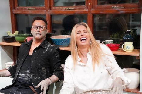 Joe Swash and Stacey Solomon covered in clay, laughing.