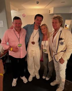 Jack Grealish with Rod Stewart and others backstage.