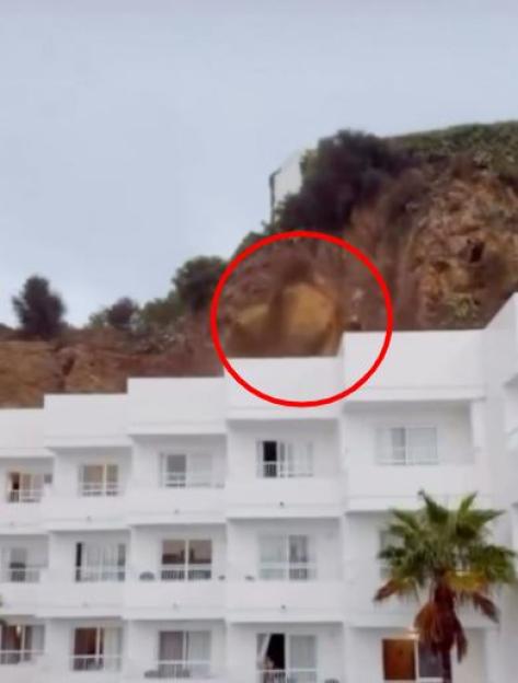 Rock fall from a cliff above a white building in Ibiza.