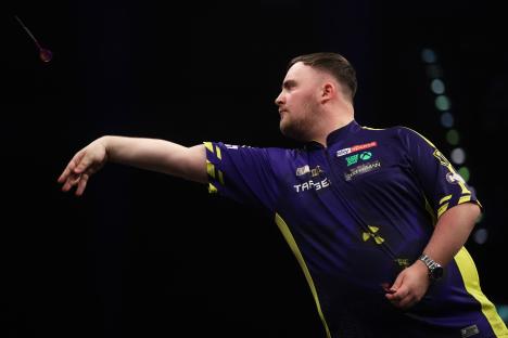 Luke Littler throwing a dart during a match.