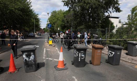 Floral tributes and people gathered on Lower Broughton Road.