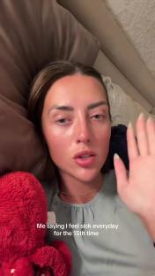 A woman lying in bed says she feels sick.