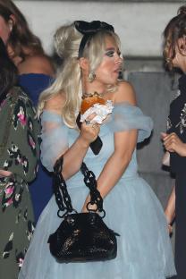 Mollie Gallagher eating a burger at an awards ceremony.