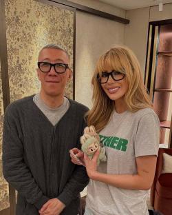 Photo of a man and woman holding a small stuffed animal.