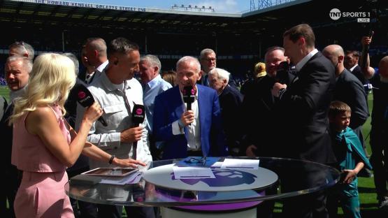 Sportscasters and guests at a stadium, conducting interviews.