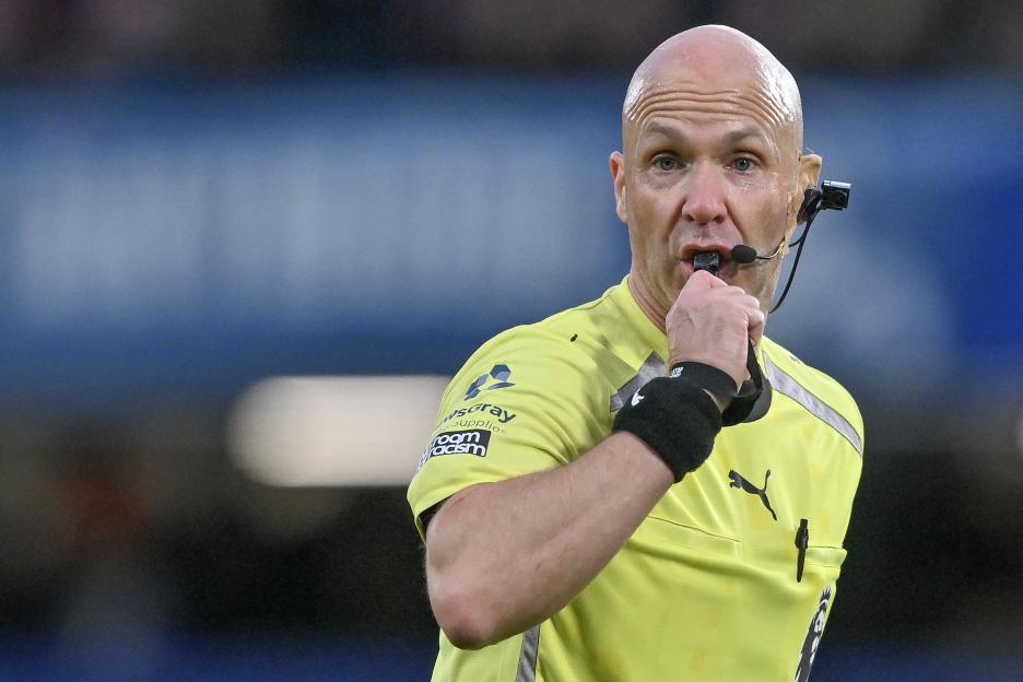 Referee Anthony Taylor blowing a whistle.