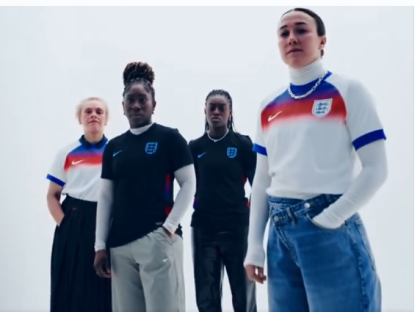 Four women wearing England soccer jerseys.