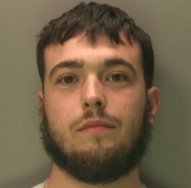 Mugshot of a young man with short brown hair and a beard.