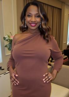 Rene Byrd, a woman who had her first child at age 48, wearing a brown dress.