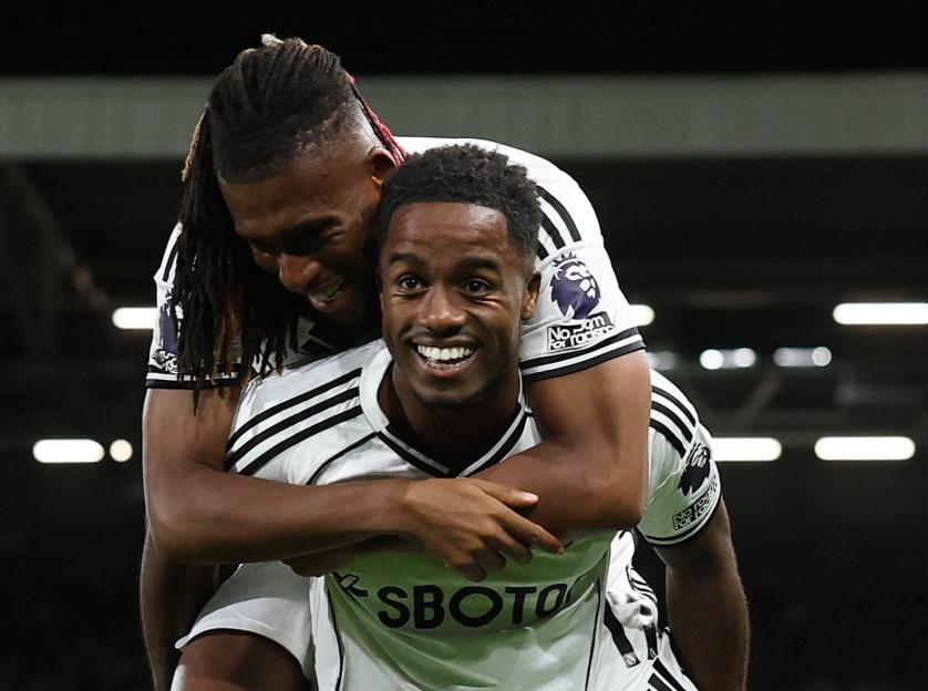 Fulham's Ryan Sessegnon celebrates with Alex Iwobi after Fulham's third goal.