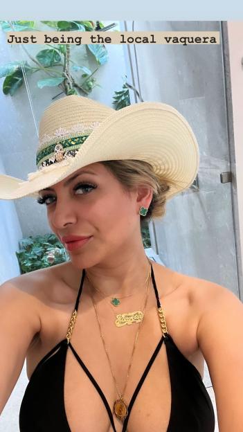 Selfie of Jasveen Sangha wearing a cowboy hat and jewelry.