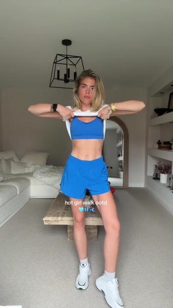 Woman in blue athletic wear showing off her physique.