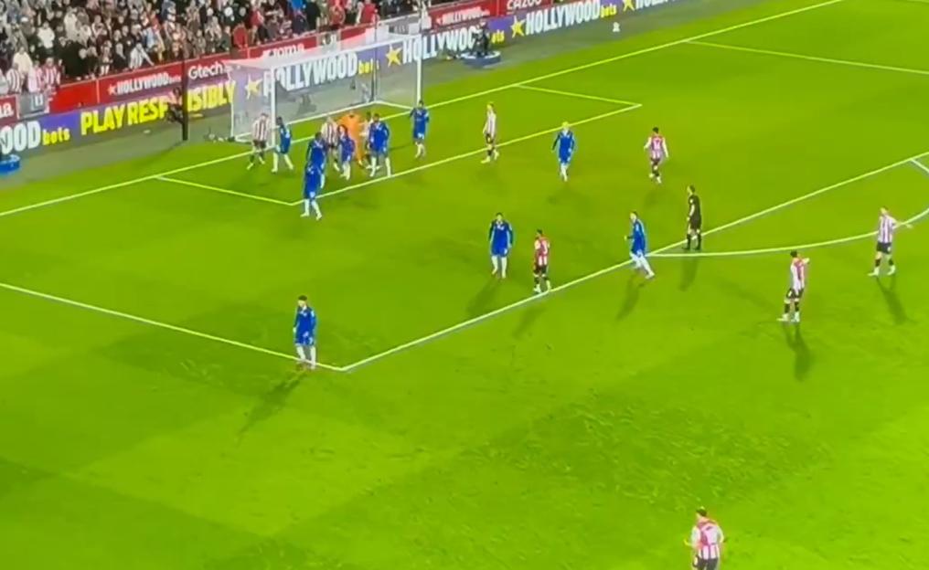 Soccer players preparing for a penalty kick.