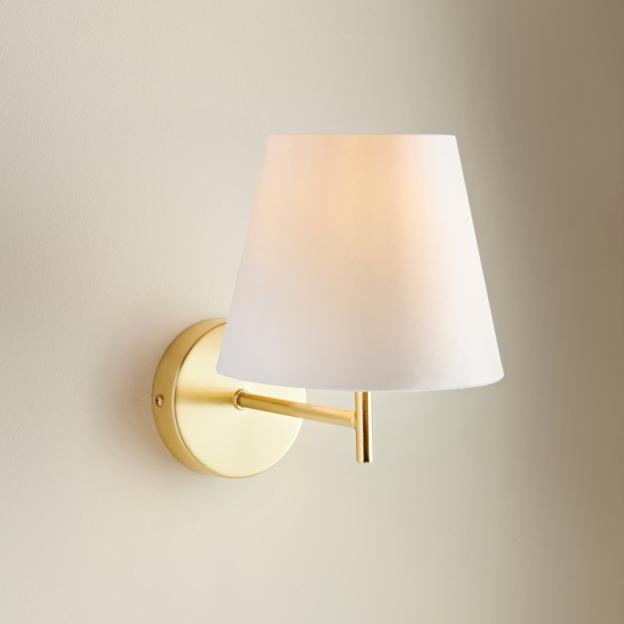 Gold wall-mounted lamp with white shade.